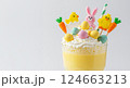 Easter dessert drink glass. Candy eggs chick bunny decoration. Holiday party food blog. Still life bright white photo 124663213
