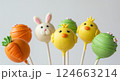 Easter themed cake pops treats. Bunny chick carrot designs. Holiday desserts party fun food. Macro bright colorful white background 124663214