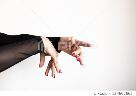 Expressive female hands with red nails in dance pose against white background Expressive female hands with red nails in dance pose against white background 124663663