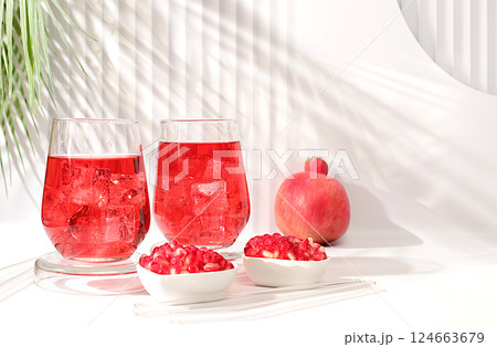 Fruit juice and ingredients, summer drink or tonic with pomegranate and ice on bright table, detox diet and weight loss concept, healthy and natural food, source of vitamin C, selective focus Fruit juice and ingredients, summer drink or tonic with pomegranate and ice on bright table, detox diet and weight loss concept, healthy and natural food, source of vitamin C, selective focus 124663679