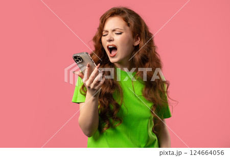 Woman quarreling while talking on mobile phone. Angry, stress on Pink. Conflict Woman quarreling while talking on mobile phone. Angry, stress on Pink. Conflict 124664056
