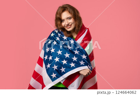 Smiling woman with national USA flag on pink background. American patriot 124664062
