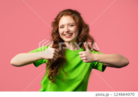 Positive woman with hand sign like, thumbs up gesture. Lady on pink background 124664070