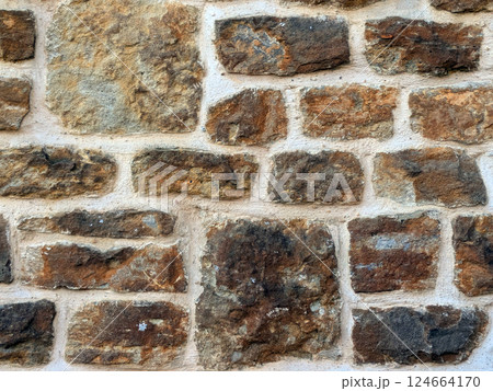 Old church wall with random handmade bricks and masonary old surface 124664170