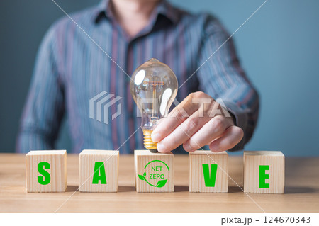 wood block with icon net zero with save and lightbulb,and reduce global warming,eco friendly investment,ESG environment social governance,Green Business Innovation and Sustainable Development concept. 124670343