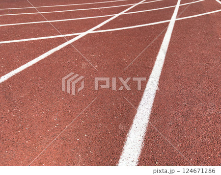 Red treadmill with the lines at the stadium. Treadmill lane on sport field. Running track on the stadium. Red treadmill in sport field. Running track 124671286