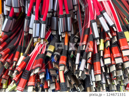 Different types of charger connectors for phones texture background. Charging or data cables. 124671331