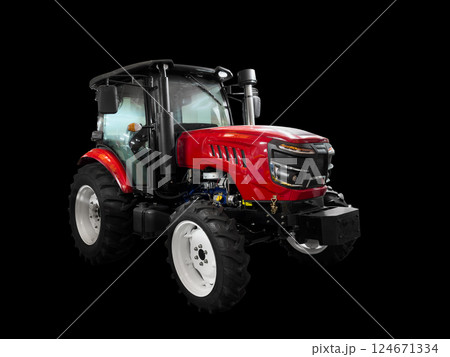 Tractor isolated on a black background. Red modern tractor. Industrial street tractor for road with a bucket isolated Tractor isolated on a black background. Red modern tractor. Industrial street tractor for road with a bucket isolated 124671334