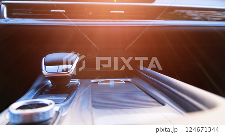 Automatic transmission shift selector in the modern car black leather interior. Selector automatic transmission in premium car. Gear shift lever. Automatic gearbox lever. 124671344