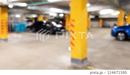 Blurred cars in car parking lot in shopping mall. Bokeh lights background. Abstract blur car parking lot for background. Blurred cars parking Blurred cars in car parking lot in shopping mall. Bokeh lights background. Abstract blur car parking lot for background. Blurred cars parking 124671380