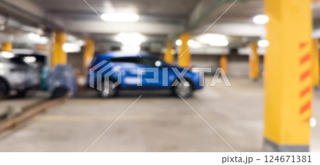 Blurred cars in car parking lot in shopping mall. Bokeh lights background. Abstract blur car parking lot for background. Blurred cars parking Blurred cars in car parking lot in shopping mall. Bokeh lights background. Abstract blur car parking lot for background. Blurred cars parking 124671381