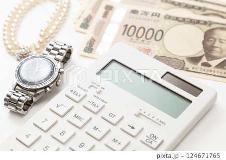 真珠のネックレスと腕時計とお金と電卓 124671765