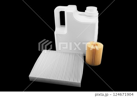 Car engine oil and filters isolated on black background. Car oil, air, fuel filters and motor oil in plastic can isolated. Quality spare parts for car service or maintenance 124671904