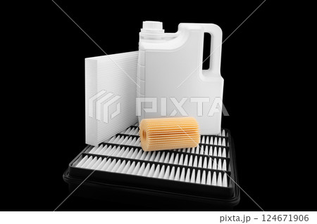 Car engine oil and filters isolated on black background. Car oil, air, fuel filters and motor oil in plastic can isolated. Quality spare parts for car service or maintenance Car engine oil and filters isolated on black background. Car oil, air, fuel filters and motor oil in plastic can isolated. Quality spare parts for car service or maintenance 124671906