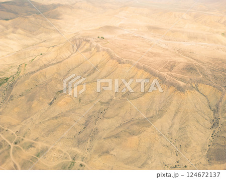 Aerial view mountain texture background. Drone view mountain valley. Beautiful view from above surface of mountain hills. Aerial view mountain texture background. Drone view mountain valley. Beautiful view from above surface of mountain hills. 124672137