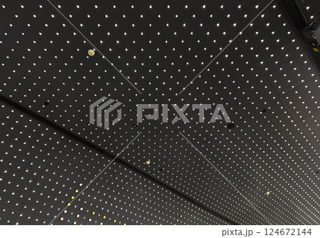 Lights and ventilation system in long line on ceiling of the  industrial building. Exhibition Hall. Ceiling factory construction 124672144