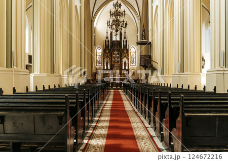 Wooden church pews in a Catholic Christian church for believers. 124672216