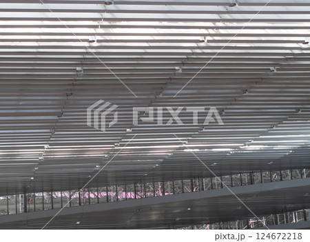 Lights and ventilation system in long line on ceiling of the industrial building. Exhibition Hall. Ceiling factory construction	Lights and ventilation system in long line on ceiling of the industrial 124672218