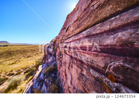 Pink Striated Rock in Desert Landscape with Sunlit Texture Perspective 124673354