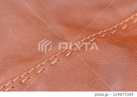Leather texture background. Part of perforated brown leather details. Perforated leather texture background. Texture leather 124673395