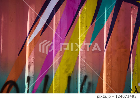 Vibrant Geometric Street Art on Corrugated Metal with Textured Depth 124673495
