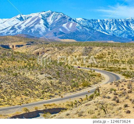 Aerial of Desert Road and Snow-Capped Mountains in Nevada Aerial of Desert Road and Snow-Capped Mountains in Nevada 124673624