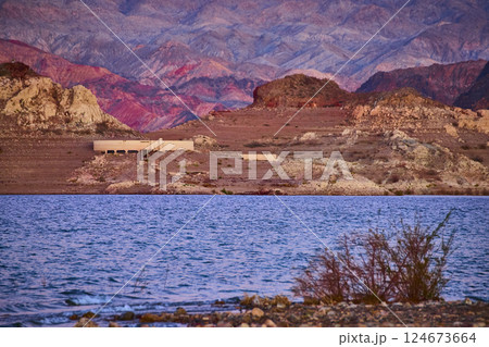 Golden Desert Lake and Abandoned Structure at Sunset Eye Level 124673664