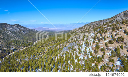 Aerial of Snow-Capped Nevada Mountains with Winding Road Aerial of Snow-Capped Nevada Mountains with Winding Road 124674092