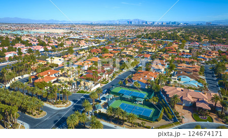 Aerial of Las Vegas Suburb with Palm-Lined Streets and Tennis Courts 124674171