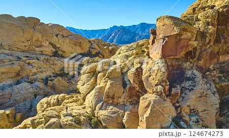 Aerial of Red Rock Canyon Sandstone Formations with Mountain Silhouette 124674273