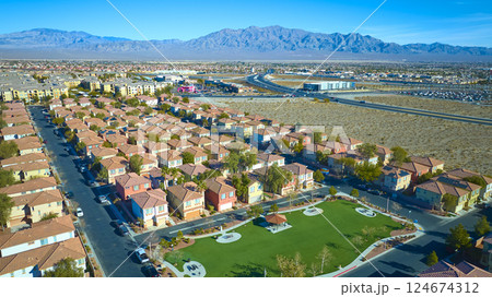 Aerial Suburban Desert Oasis Near Las Vegas with Mountain Backdrop 124674312