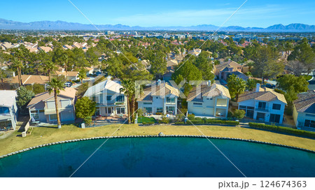 Aerial of Serene Suburban Neighborhood with Water and Greenery 124674363