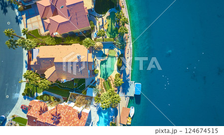 Aerial Top Down of Luxury Waterfront Homes with Pools and Palm Trees Aerial Top Down of Luxury Waterfront Homes with Pools and Palm Trees 124674515
