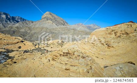 Aerial of Red Rock Formations and Mountains in Nevada Desert 124674565