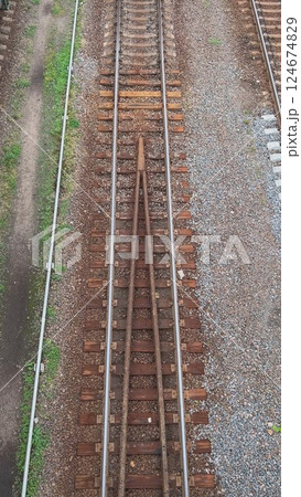 Railway Tracks Merging Into Single Line, Creating Intersection Point for Trains 124674829
