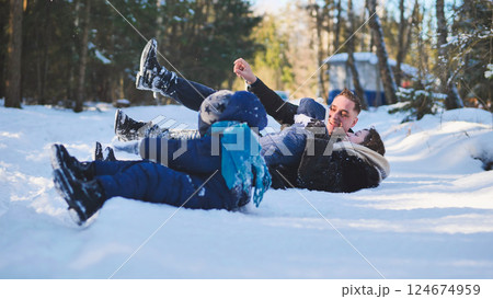 Family members playing together in snowy landscape, sharing laughter and creating winter memories amid sparkling, frosty scenery Family members playing together in snowy landscape, sharing laughter and creating winter memories amid sparkling, frosty scenery 124674959