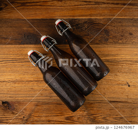 Old beer bottle, brown glass vintage beerbottle, a quality traditional time-tested drink symbol Old beer bottle, brown glass vintage beerbottle, a quality traditional time-tested drink symbol 124676967