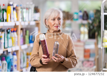 Mature woman choosing hair spray 124677232