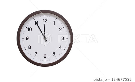 A simple round wall clock with a dark brown frame and a white face displaying 11:55/23:55. Isolated on a white background, perfect for time-related concepts, deadlines, and schedule themes. A simple round wall clock with a dark brown frame and a white face displaying 11:55/23:55. Isolated on a white background, perfect for time-related concepts, deadlines, and schedule themes. 124677553