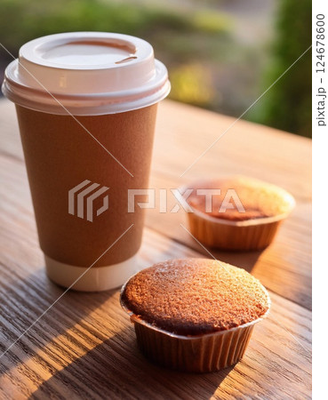 Paper cup of coffee and cake on wooden table Paper cup of coffee and cake on wooden table 124678600