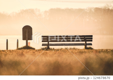 Bench at bathing area at lake in the morning Bench at bathing area at lake in the morning 124678670