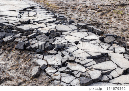 This is a close up of an aging and cracked asphalt road surface This is a close up of an aging and cracked asphalt road surface 124679362
