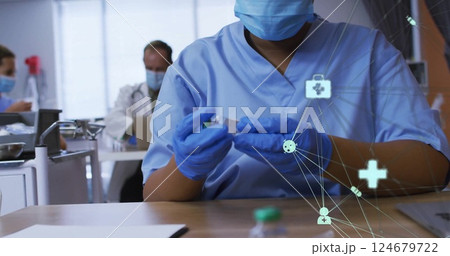 Healthcare network image over medical professionals working in clinic 124679722