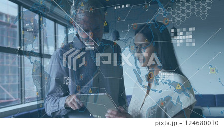Global data network image over business professionals discussing information on tablet Global data network image over business professionals discussing information on tablet 124680010