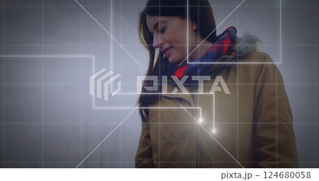 Grid lines and glowing points image over person in brown jacket outdoors Grid lines and glowing points image over person in brown jacket outdoors 124680058