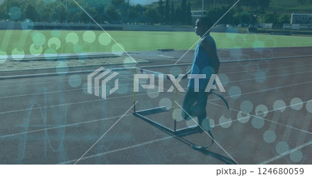 Athlete with prosthetic leg on track with data processing image over scene Athlete with prosthetic leg on track with data processing image over scene 124680059