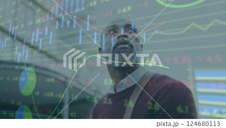 Image of financial data processing over african american man walking in city 124680113