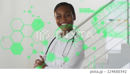 Image of green medical data processing over african american female doctor smiling at hospital 124680342