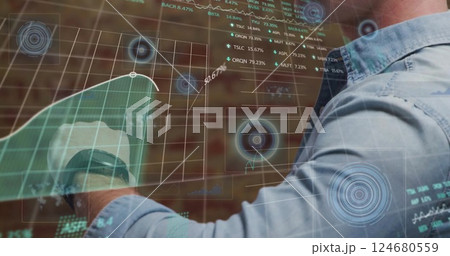 Image of stock market and data processing over caucasian man checking smartwatch Image of stock market and data processing over caucasian man checking smartwatch 124680559