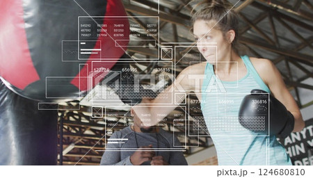 Image of digital data processing over biracial woman boxing with male instructor 124680810